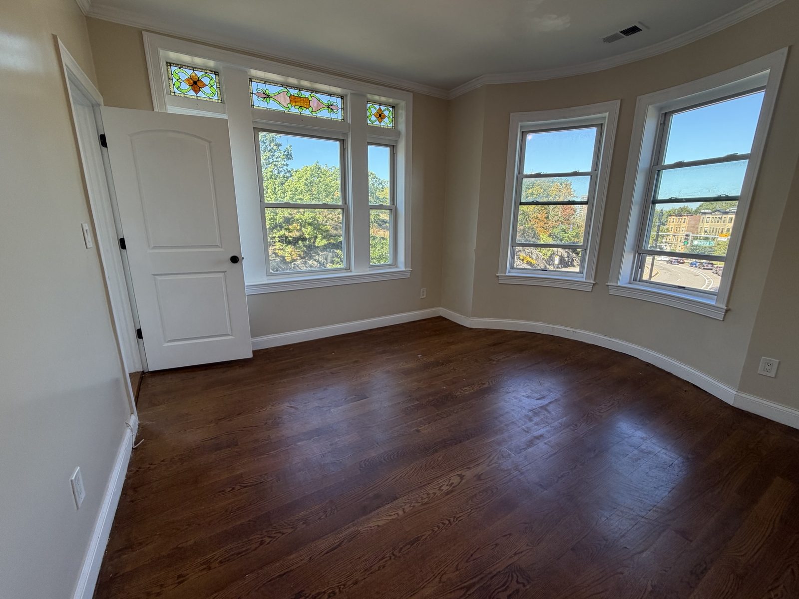 Corner room with stained glass and curved windows