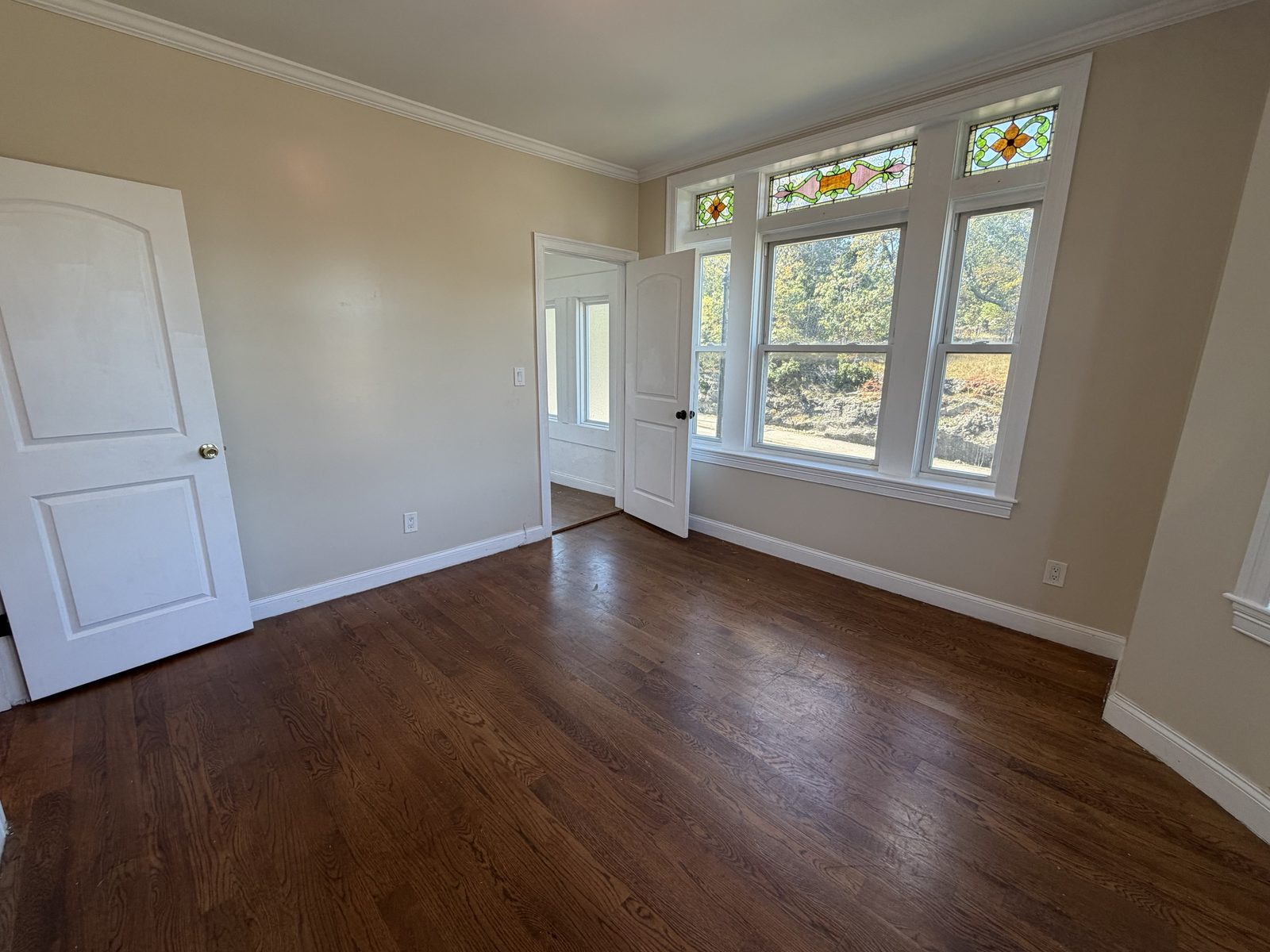 Room with stained glass windows and hardwood floors