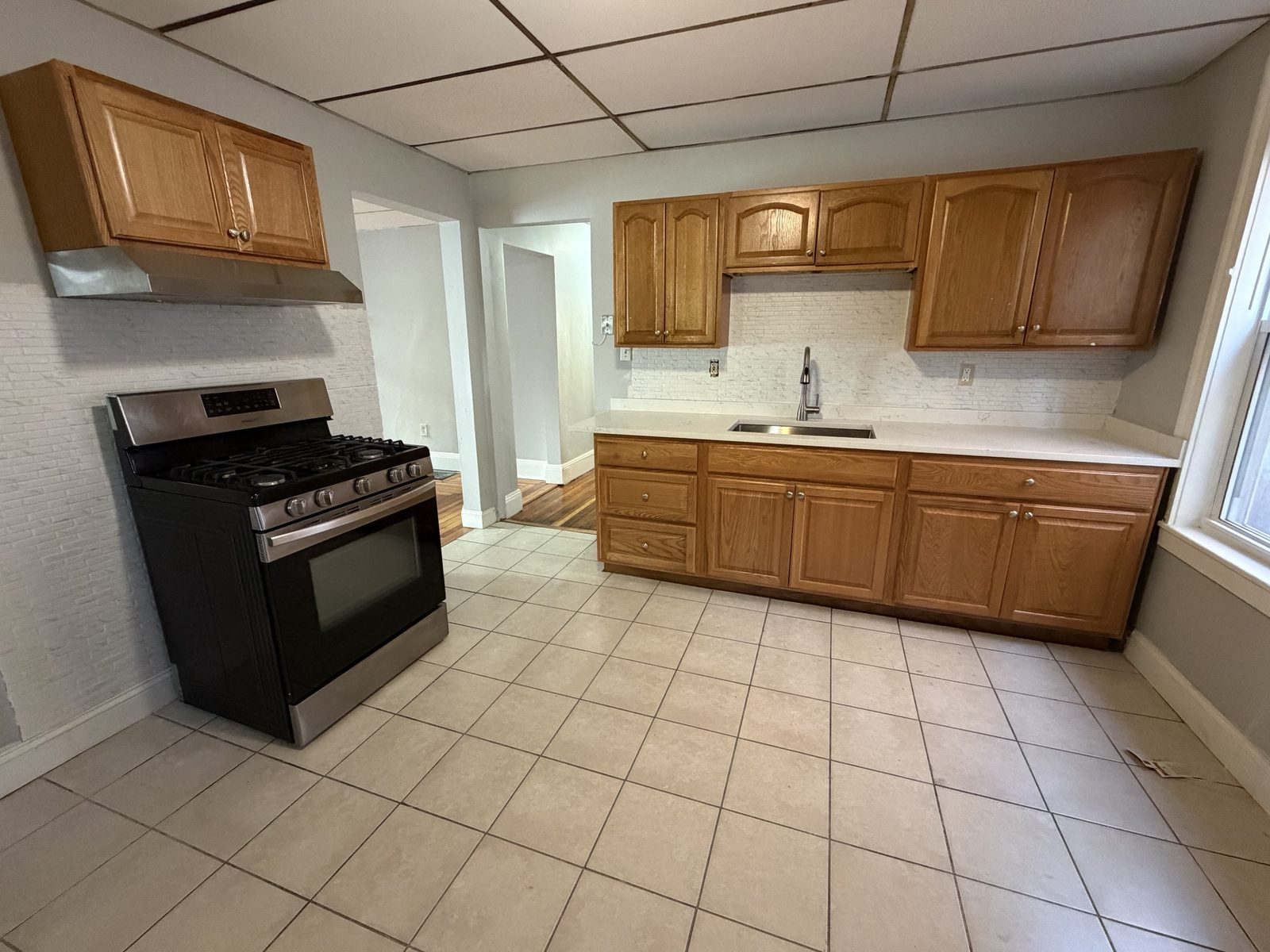 Kitchen with stainless steel range and wood cabinets