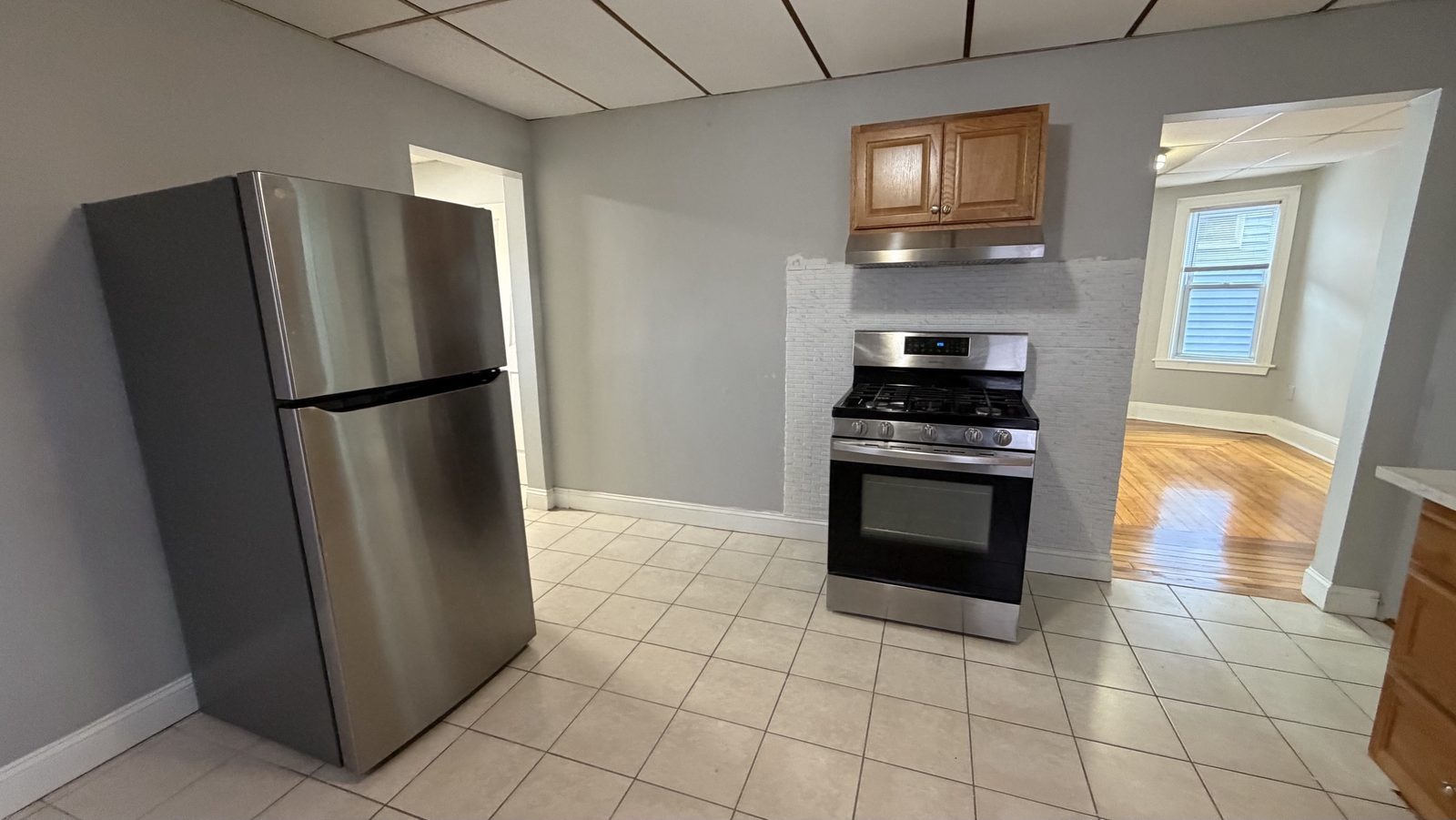 Eat-in kitchen with stainless fridge, open to the living room